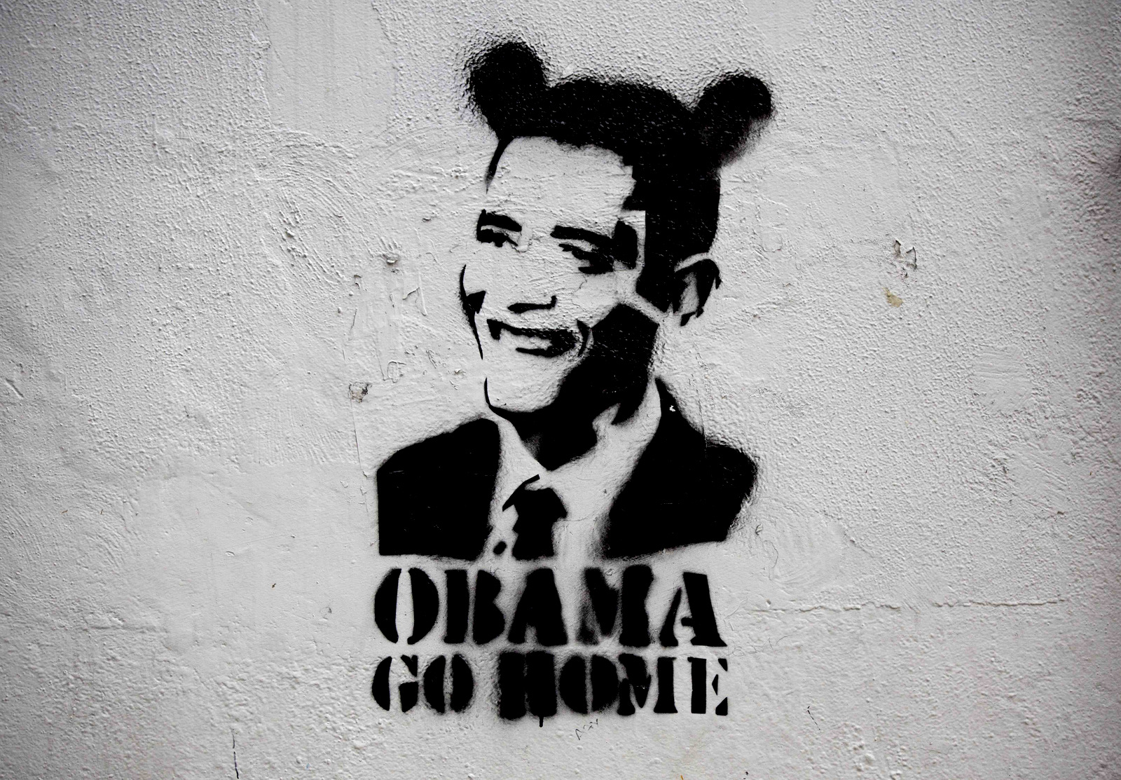 An image of President Barack Obama wearing fake ears and the slogan "Obama go home" on a street wall in Caracas, Venezuela. Venezuelan President Nicolas Maduro regularly sets social media afire with support, with heavily trending anti-U.S. campaigns such #ObamaYankeeGoHome and #ObamaRepealTheExecutiveOrder, which denounced U.S. sanctions on members of Maduro’s administration. (AP/Ariana Cubillos)