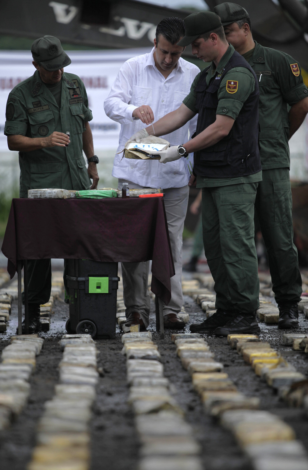 Tareck El Aissami inspects seized cocaine in Ciudad Bolivar, Venezuela, Sunday June 26, 2011. El Aissami said authorities seized more than 5.5 tons of cocaine in eastern Venezuela. Venezuela is a transshipment point for Colombian cocaine destined for the United States, Europe and the Caribbean. (AP/Ariana Cubillos)
