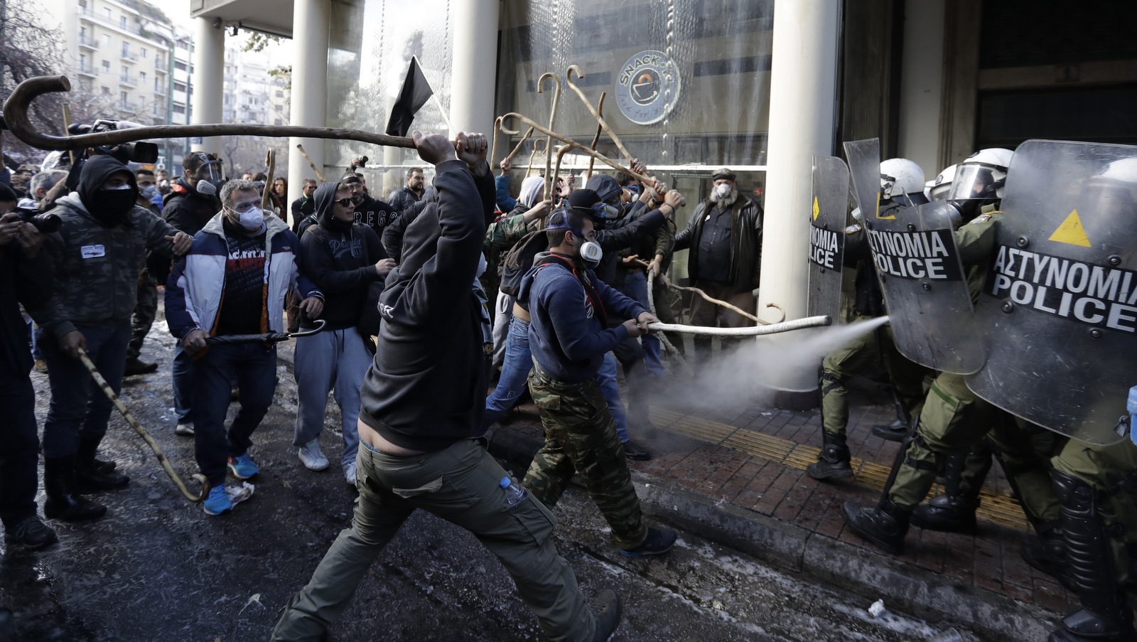 Riot police clashes with protesting farmers outside the greek Agriculture Ministry, in Athens, Wednesday, March 8, 2017. Police fired tear gas to prevent farmers from forcing their way into the ministry building, while protesters responded by throwing stones. No injuries or arrests were reported. Protesters are angry at increases in their tax and social security contributions, part of the income and spending cuts Greece's left-led government has implemented to meet bailout creditor-demanded budget targets.(AP/Thanassis Stavrakis)