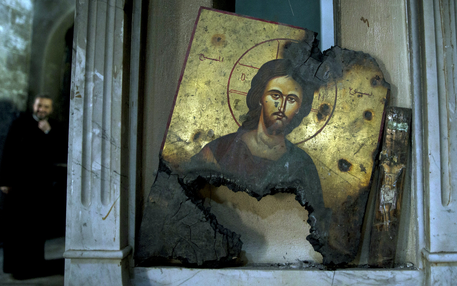 A half-burned image of Christ is placed next to a wall at a Greek Orthodox church in Maaloula, Syria, March 3, 2016. Maaloula, an ancient Christian town 40 miles northeast of Damascus, changed hands several times in the war. Its historic churches pillaged by Syrian rebels and buildings riddled with shrapnel reflect fierce fighting that devastated the town two years ago. (AP/Pavel Golovkin)