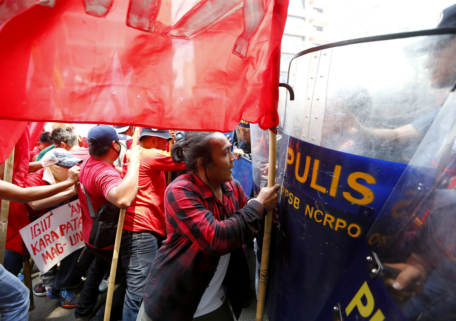 Protesters clash with riot police as they attempt to force their way closer to U.S. Embassy to mark May Day celebrations in Manila, Philippines, Monday, May 1, 2017. As in the past years, workers mark Labor Day with calls for higher wages and an end to the so-called "Endo" or contractualization.