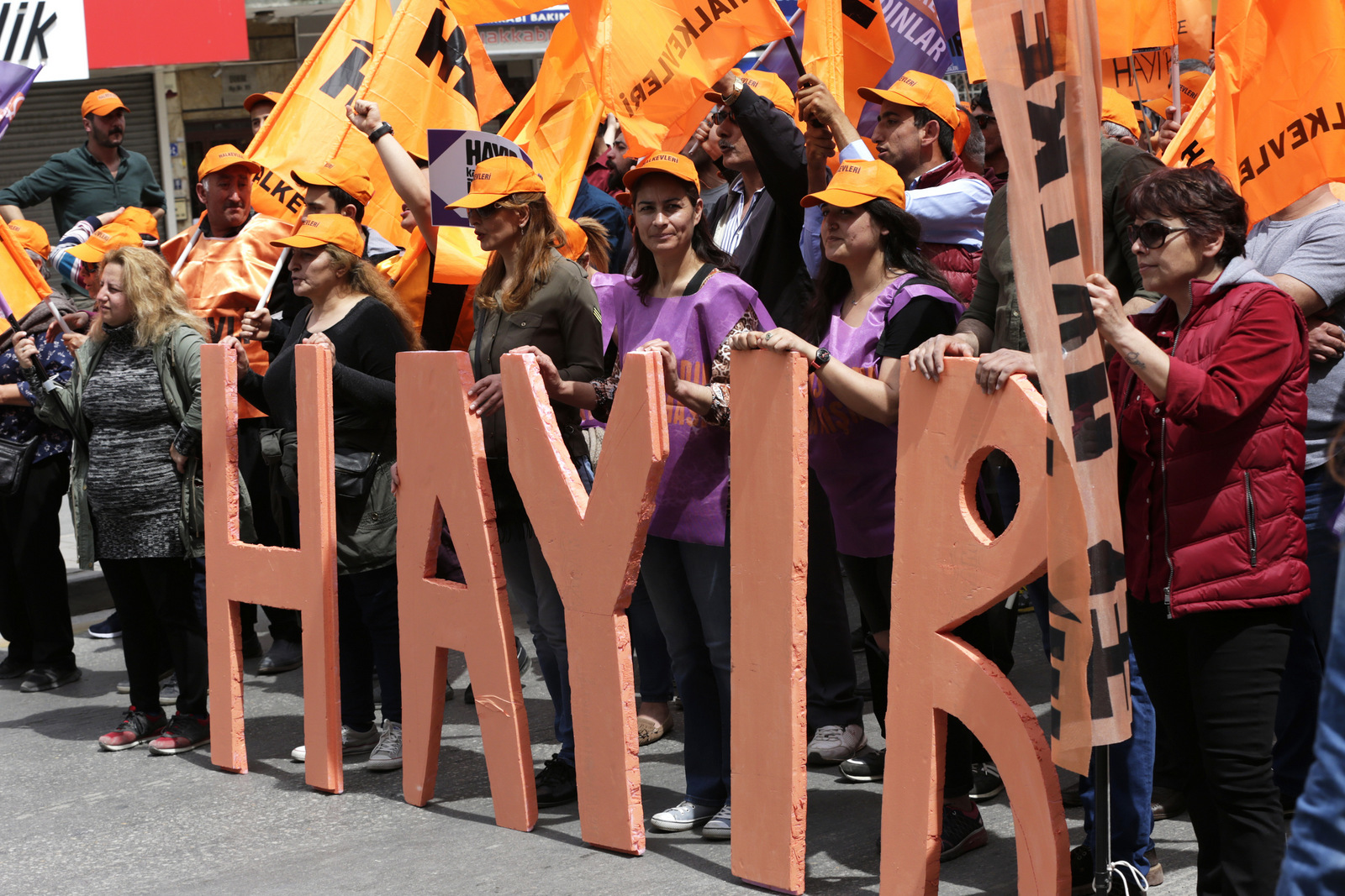 Protesters stands behind letters which reads in Turkish "NO'' during a May day protest in Ankara, Turkey , Monday, May 1, 2017. Workers and activists marked May Day with defiant rallies and marches for better pay and working conditions Monday.
