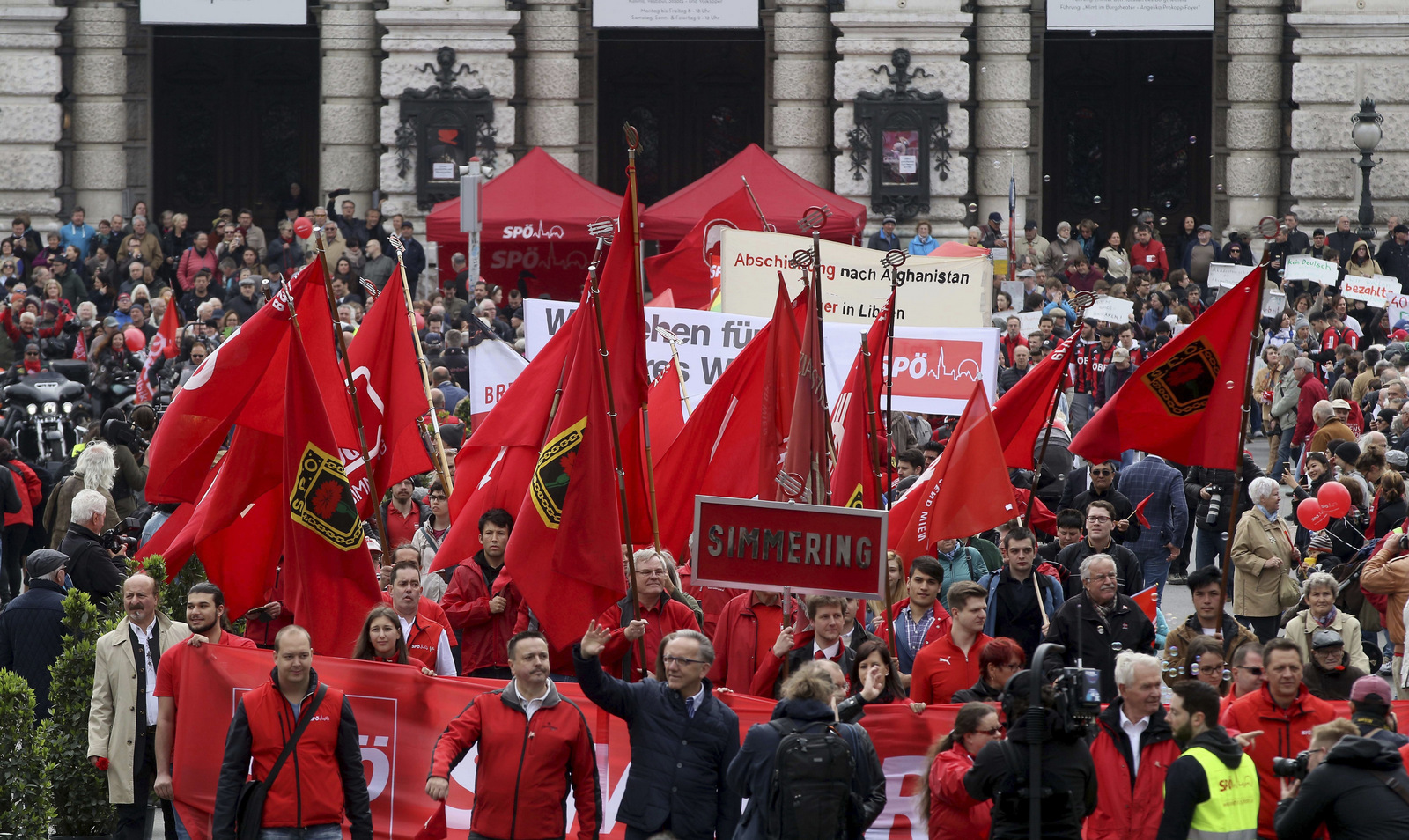 Participants of the traditional May Day celebrations, organized by the Austrian Social Democrats, SPOE, and trade unions walk with flags and banners in Vienna, Austria, Monday, May 1, 2017.