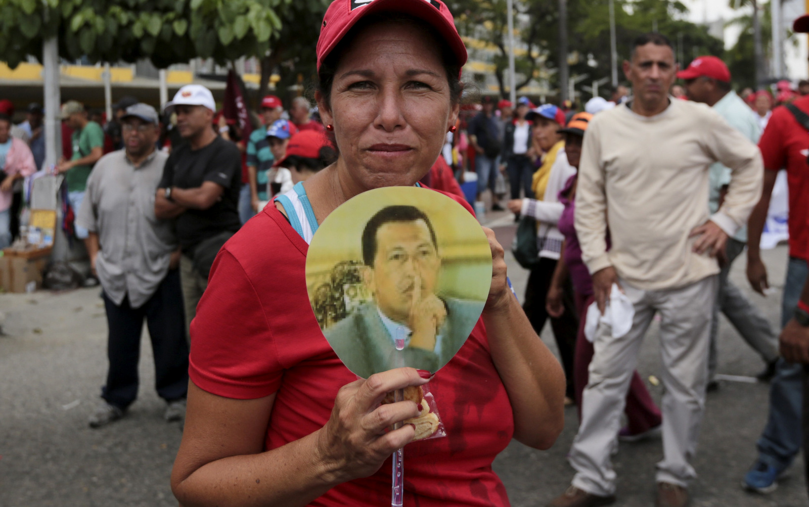 A government supporter holds an image of Venezuela's late president Hugo Chavez, during a march in Caracas, Venezuela, Wednesday, April 19, 2017. (AP/Fernando Llano)