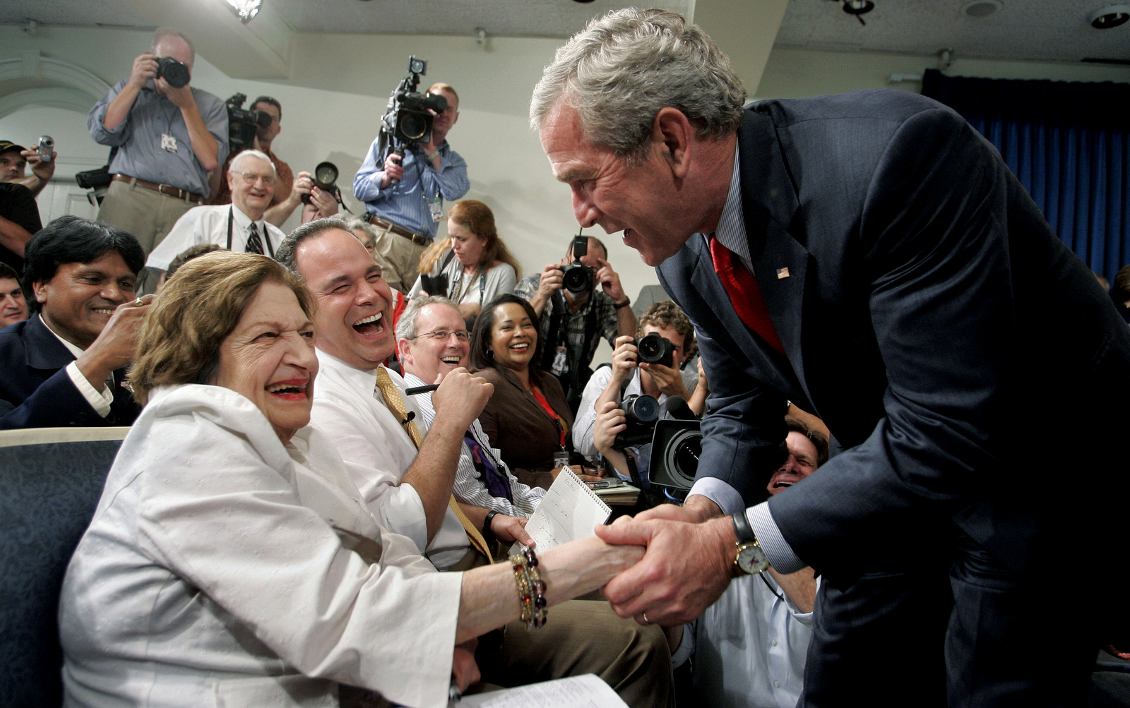 President Bush, right, greets veteran White House correspondent Helen Thomas. Thomas, was a correspondent for more than 50 years before she fired due to comments her critics described as anti-Semitic. (AP/Charles Dharapak)