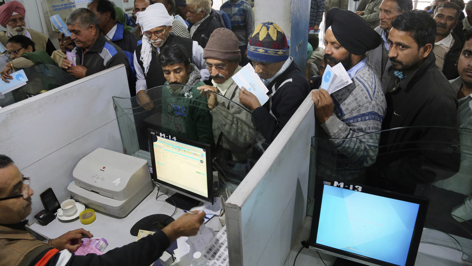 Indians stand in line to deposit discontinued notes in a bank in Jammu and Kashmir, India,, Dec. 30, 2016. India yanked most of its currency bills from circulation without warning on Nov. 8, delivering a jolt to the country's high-performing economy and leaving countless citizens scrambling for cash. (AP/Channi Anand)