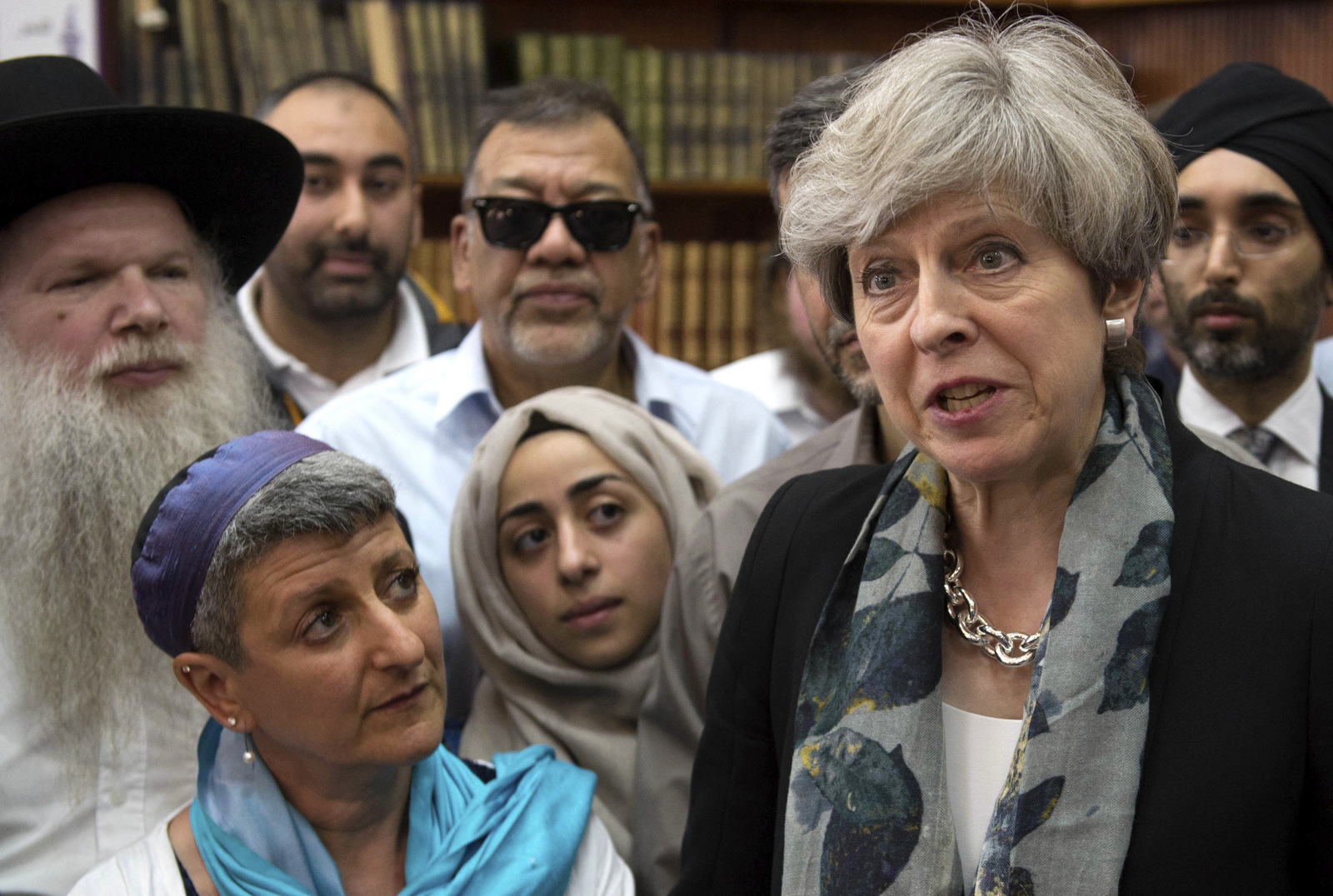 Britain's Prime Minister Theresa May, right, talk to faith leaders at Finsbury Park Mosque in north London, after a man plowed his vehicle into a crowd of worshippers outside a north London mosque early Monday. (Stefan Rousseaul/AP)