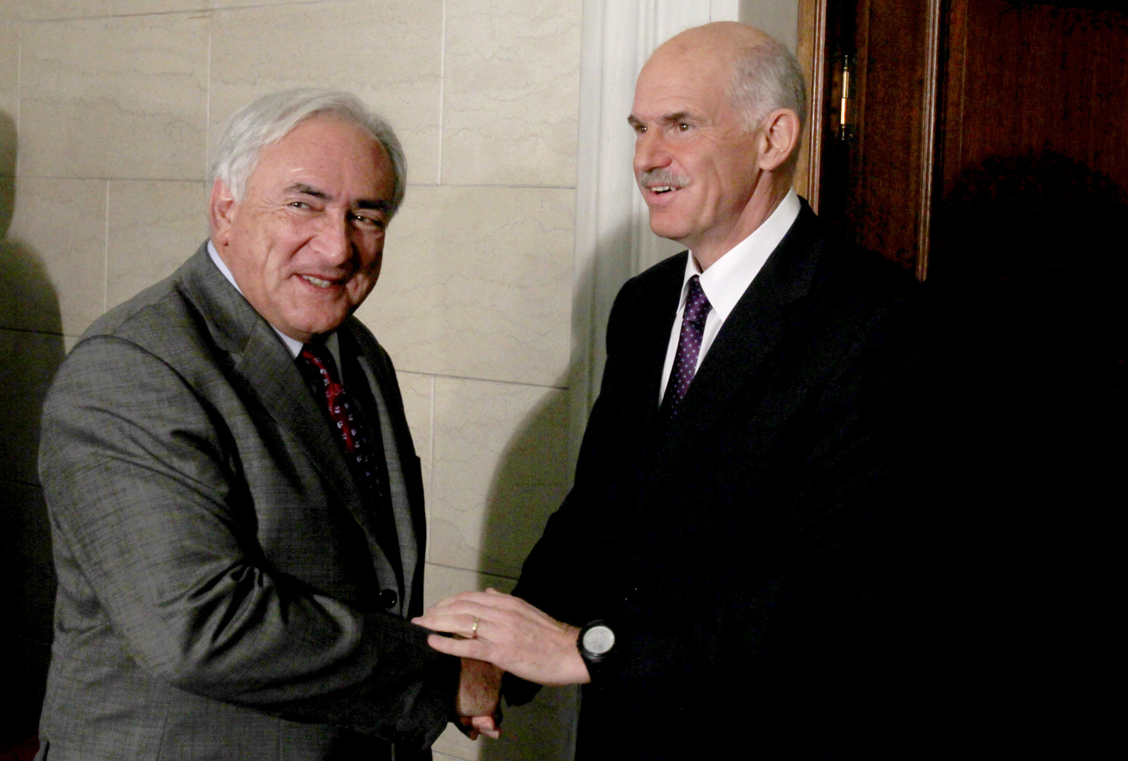 Greek Prime Minister George Papandreou, right, welcomes the head of the International Monetary Fund Dominique Strauss-Kahn at his office in Athens on Dec. 7, 2010. Strauss-Kahn was in Greece to negotiate terms of the repayment of the three-year euro110 billion ($150 billion) bailout loan intended to saved the debt-ridden country from default. (AP/Thanassis Stavrakis)
