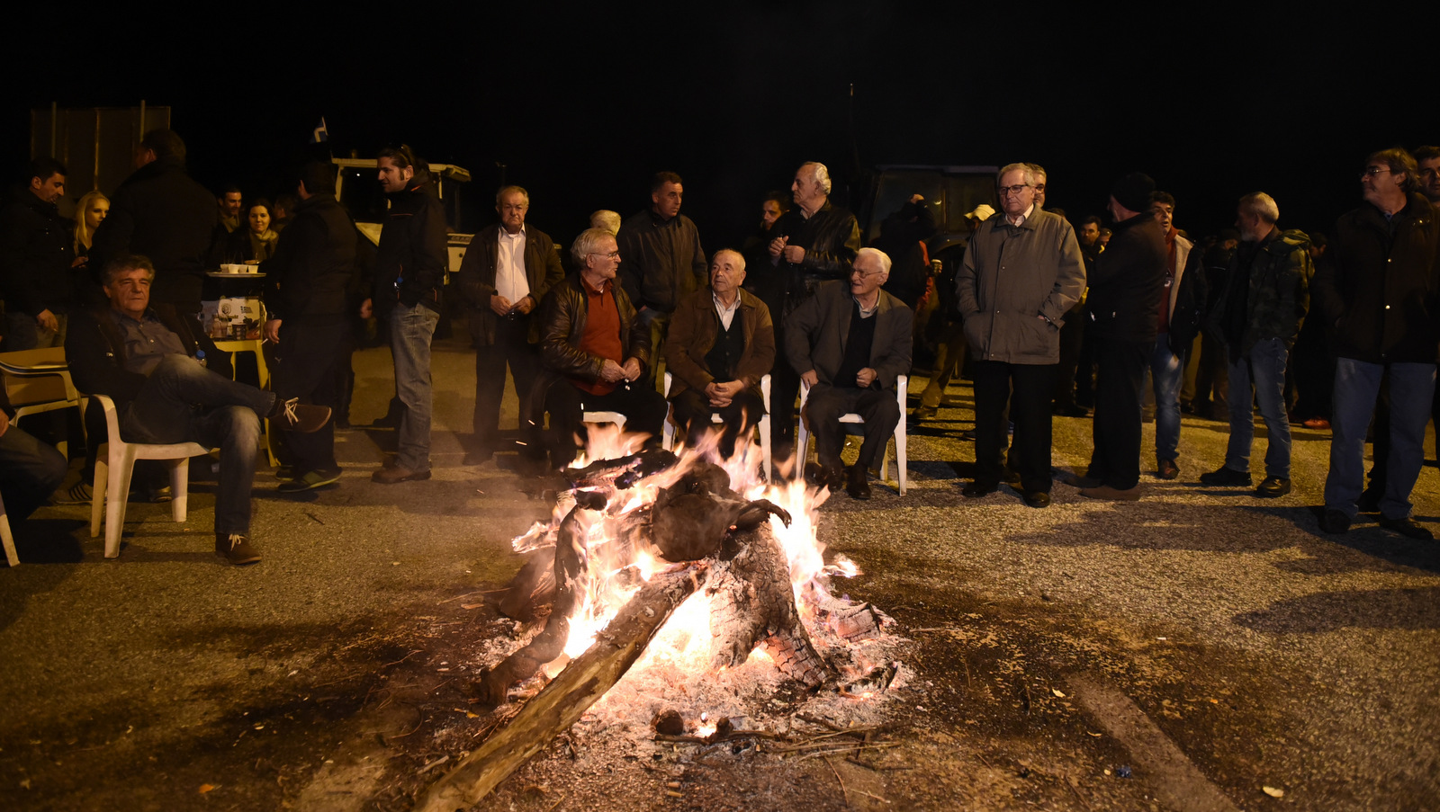 In this Feb. 2, 2016 photo farmers stand behind a makeshift fire in front of tractors, near Kerdilia, Greece. Combine a rapidly aging population, a depleted work force and leaky finances and any country’s pension system would be in trouble. For debt-hobbled, unemployment-plagued Greece, it’s a nightmare.(AP/Giannis Papanikos)
