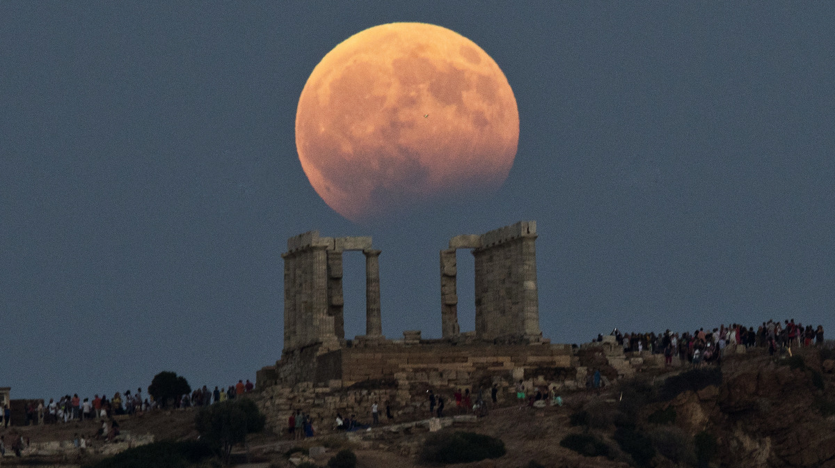The August full moon rises above the 5th Century BC Temple of Poseidon at Cape Sounio, south of Athens, on Aug. 7, 2017. More than a hundred of Greece's ancient sites _ but not the Acropolis in Athens _ and museums were kept open until late Monday and concerts organized to allow visitors to enjoy the full moon, which is accompanied by a partial lunar eclipse. (AP/Petros Giannakouris)