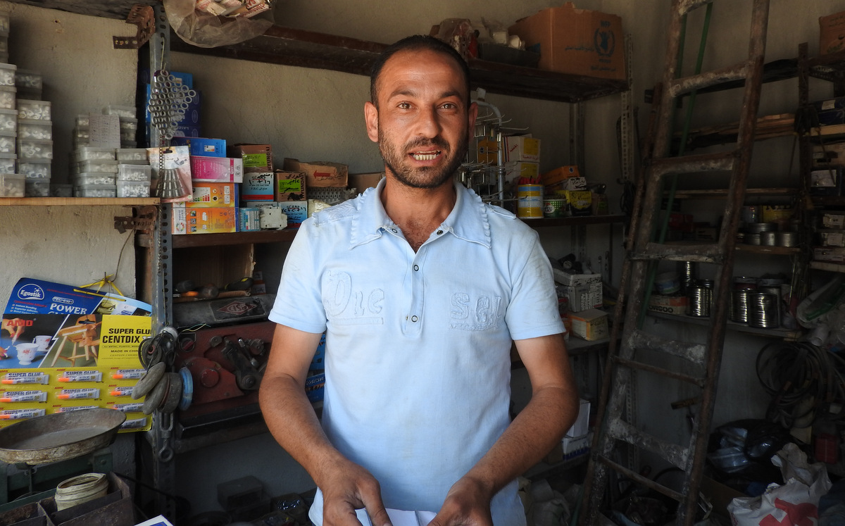 The owner of small hardware shop in eastern district Bab al-Hadid, The shop owner, who wished to remain anonymous, said he fled life under the rule of Syria's rebels groups, returning only the government restored the rule of law in the area. (Eva Bartlett/MintPress News)