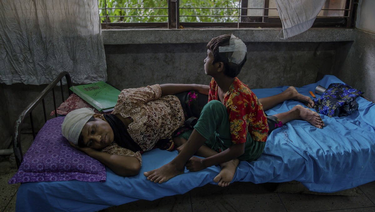 Rohingya woman Dildar Begum and her daughter Noor Kalima, who crossed over to Bangladesh recover at Sadar Hospital in Cox's Bazar, Bangladesh, Wednesday, Sept. 27, 2017. Begum said she and her daughter Noor Kalima, got stabbed by Myanmar soldiers and her husband was killed. (AP Photo/Dar Yasin)