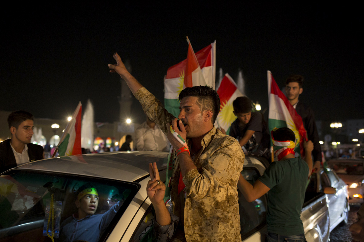A man with 'yes' shaved into his hair chants through a speaker in the streets of Irbil after polling stations closed on Monday, Sept. 25, 2017. (AP/Bram Janssen)