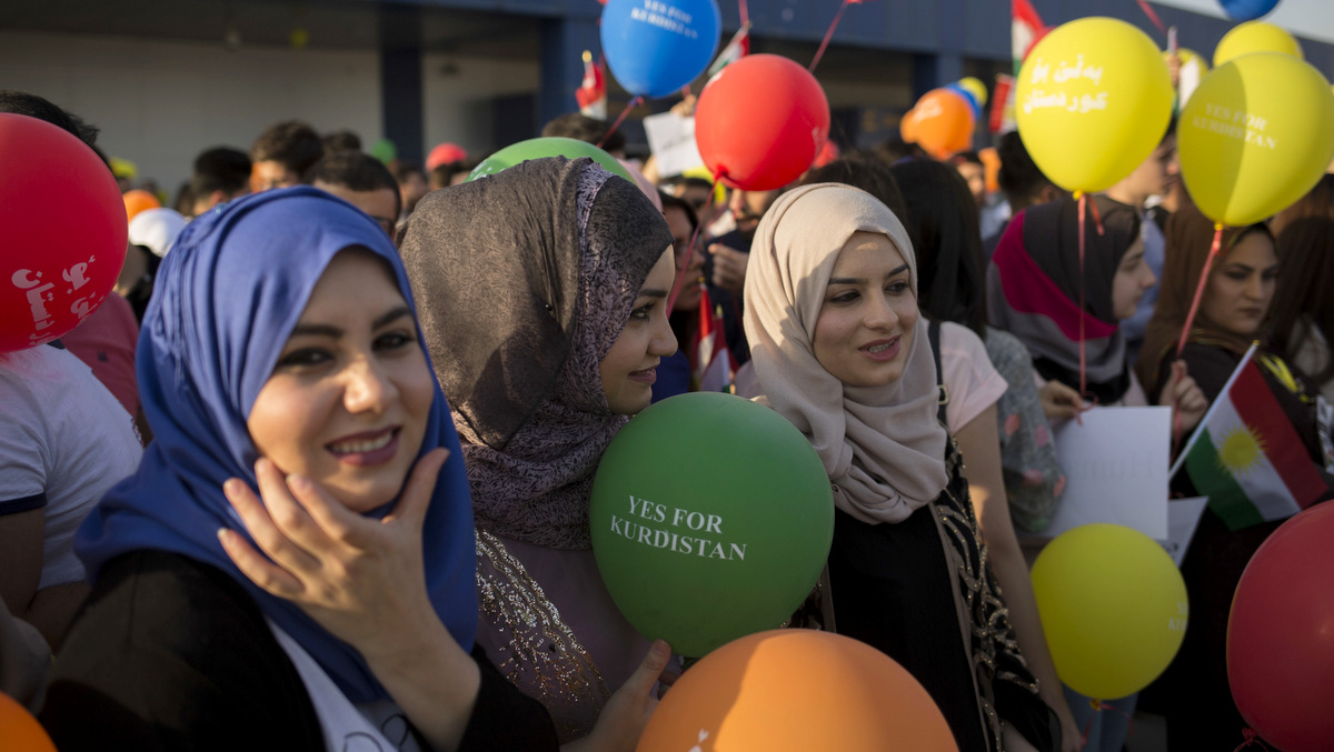 Kurdish women hold balloons to protest against the flight ban issued by the Iraq federal government outside the Irbil International Airport in Iraq, Friday, Sept. 29, 2017. (AP/Bram Janssen)