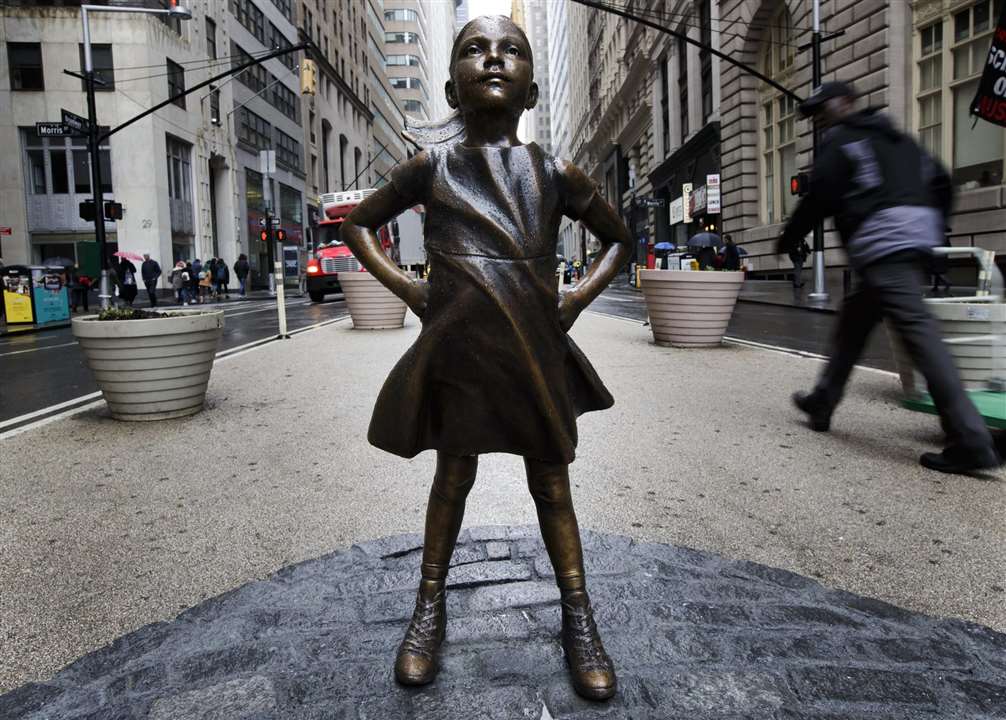 1 / 1 Fearless Girl has become a symbol of feminist strength and possibility. Photograph: Mark Lennihan/Associated Press