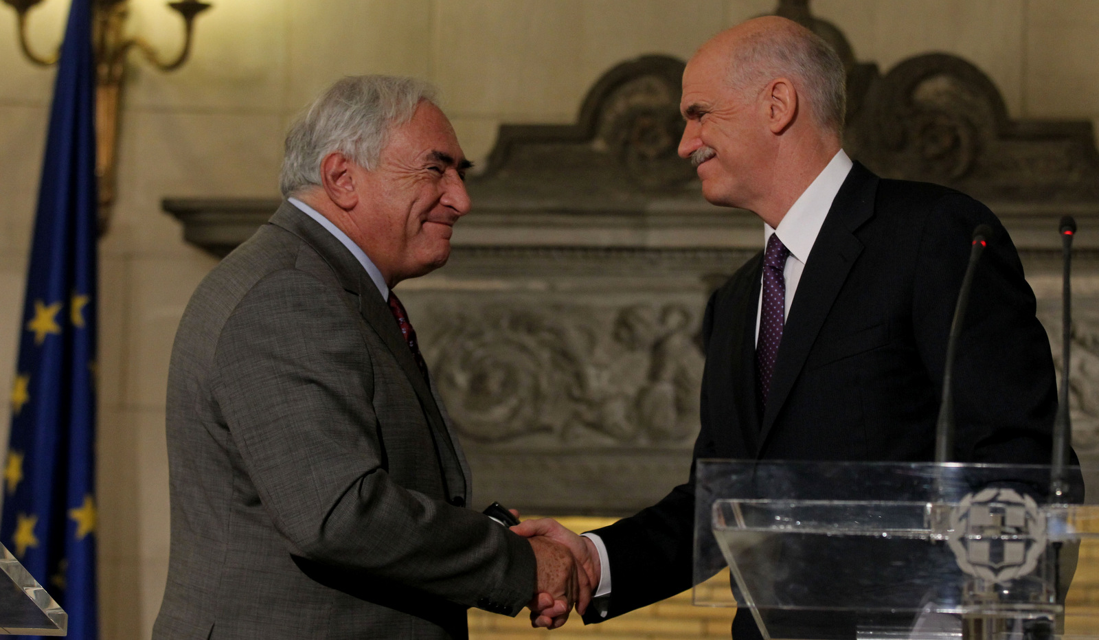 Greek Prime Minister George Papandreou, right, shakes hand with the head of the International Monetary Fund, Dominique Strauss-Kahn, during a joint news conference in Athens, Dec. 7, 2010. (AP/Thanassis Stavrakis)