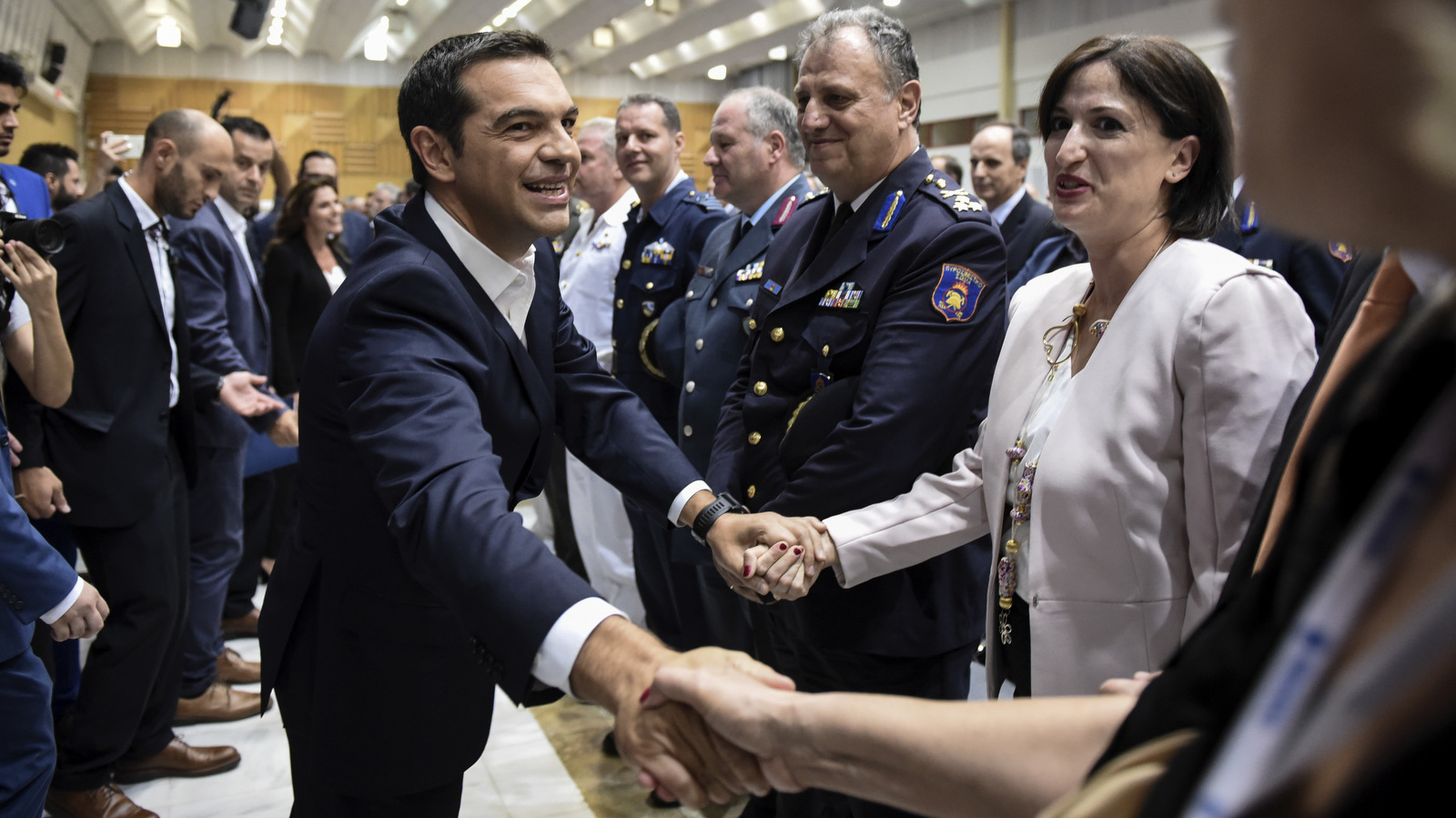 Greece's Prime Minister Alexis Tsipras greets attendants at the inauguration ceremony of Thessaloniki International Trade Fair, in Thessaloniki, Sept. 9, 2017. As the Prime Minister was delivering his speech, protesters held anti-austerity rallies outside the of the fair. (AP/Giannis Papanikos)