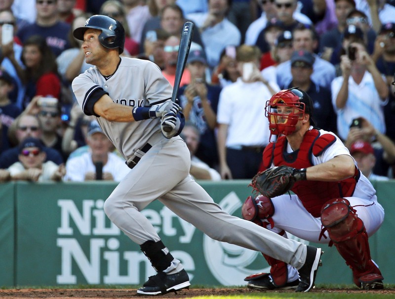 Derek Jeter follows through on a single in the third inning against the Boston Red Sox in a baseball game. He swings and sets off running. Behind him is the catcher and the audience in the stands.