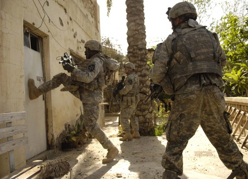 File: A U.S. Army Soldier kicks in the door of a building during a search in Buhriz, Iraq, March 14, 2007. (U.S. Air Force Staff Sgt. Stacy L. Pearsall / Flickr)