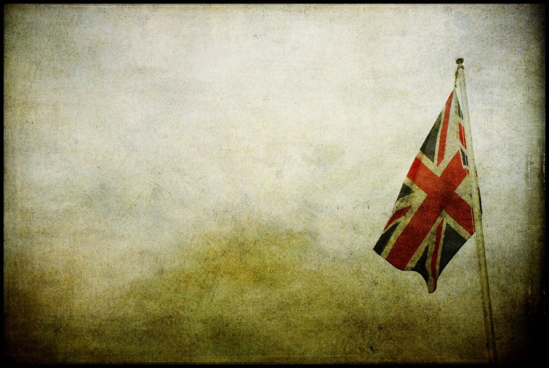 A Union Jack flag hangs against a desolate blank background.
