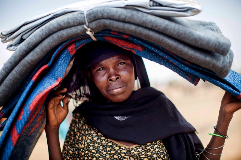 File: In this photo taken Wednesday, June 11, 2014 and released by the United Nations African Union Mission in Darfur (UNAMID), a woman carries blankets and carpets on her head at the Zam Zam refugee camp for internally displaced people (IDP) in North Darfur, Sudan. \(AP Photo/UNAMID, Albert Gonzalez Farran)