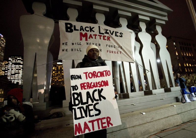 Signs read Black Lives Matter at a protest.