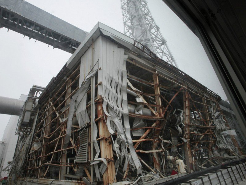 A blown out reactor building, with strips of it falling off from destructive forces.