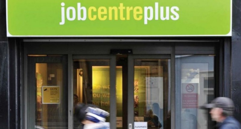 The doors of a Jobcentre Plus, with a client entering and another exiting.