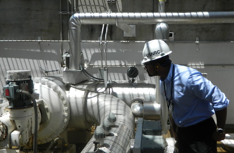NRC Engineering Area Assistant Lead Inspector Atif Shaikh examines pipes during the May 2013 inspection at the Browns Ferry plant. (Nuclear Plant - Nuclear Regulatory Commission / Flickr)