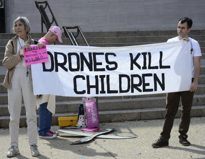 File: Two activists hold a banner reading Drones Kill Children at a October 4, 2014 rally outside the Smithsonian Air And Space Museum to protest an ongoing exhibition glorifying the use of unmanned military aircraft known as "drones." (Flickr / Stephen Melkisethian)