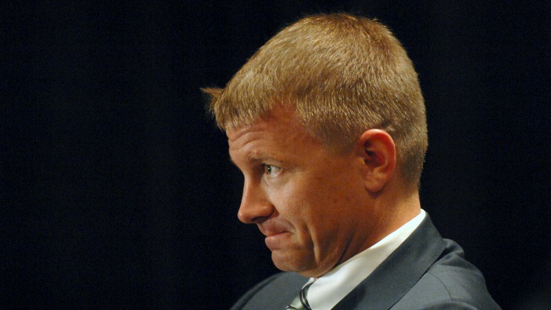 A headshot of Erik Prince, frowning, wearing a suit.