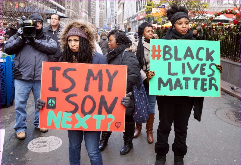 File: A Black Lives Matter rally on November 28, 2014 in New York City. Two marchers hold signs reading Is My Son Next and #BlackLivesMatter. (Flickr / The All-Nite Images)