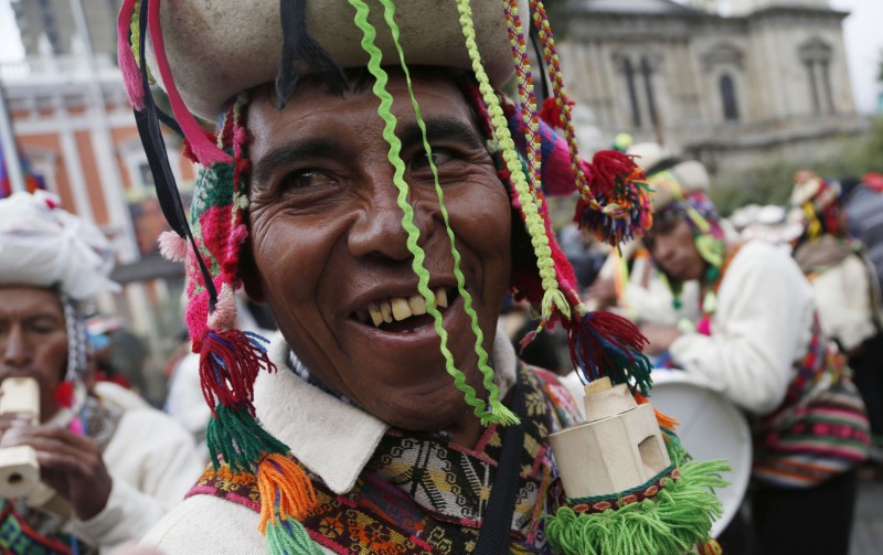 In this Thursday, Jan. 22, 2015 photo, indigenous men play traditional instruments in front of the presidential palace before the swearing-in ceremony of Bolivia's President Evo Morales in La Paz, Bolivia. Morales began a third term, making him the Andean nation's longest-serving leader, riding high on a wave of unprecedented growth and stability. (AP Photo/Juan Karita)