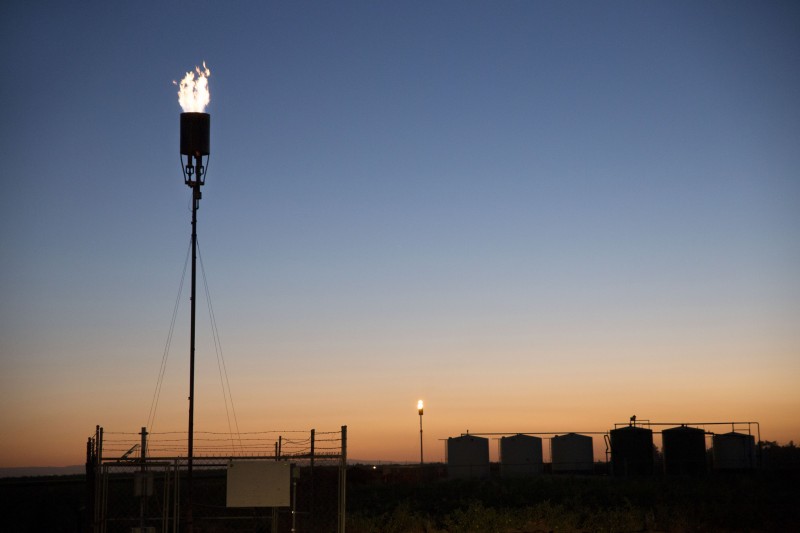 Two flares burn oil field waste gas in the night sky across the street from the Arvin High School, in Arvin California. A recent study of California water supplies found dangerous levels of fracking chemicals. (Flickr / Sarah Craig Faces of Fracking)