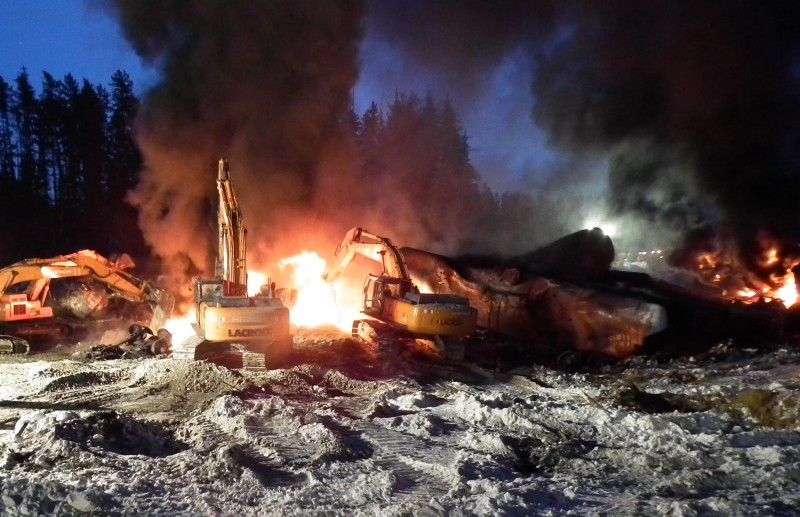 In this Feb. 16, 2015, file photo, provided by the Transportation Safety Board of Canada, workers fight a fire after a crude oil train derailment south of south of Timmins, Ontario. A federal court blocked attempts to keep dangerous oil trains off the rails due to safety concerns, keeping them rolling until at least May 2015. (AP Photo/Transportation Safety Board of Canada, File)