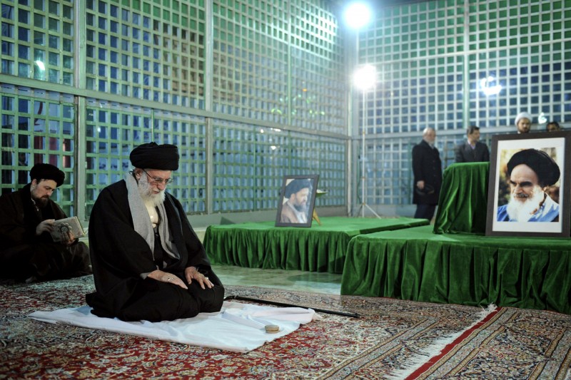 In this photo released by an official website of the office of the Iranian supreme leader, Supreme Leader Ayatollah Ali Khamenei prays, at the grave of the late revolutionary founder Ayatollah Khomeini, during his visit to mark the anniversary of the 1979 Islamic revolution, just outside Tehran, Iran, Wednesday, Jan. 28, 2015. Ayatollah Khomeini's grandson Hassan prays at background. (AP Photo/Office of the Iranian Supreme Leader)