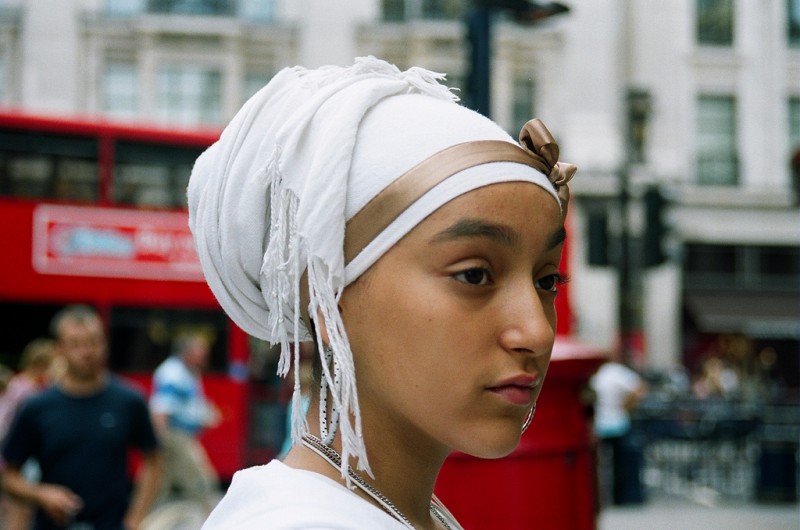 A woman in London, England wearing a white hijab headscarf held in place with a brown ribbon, August 5, 2009. While the mainstream media focuses on "happy assimilated" vs. "angry extremist" Muslims, the reality of Islamic life in the West is far more complex. (Flickr / Nefatron)