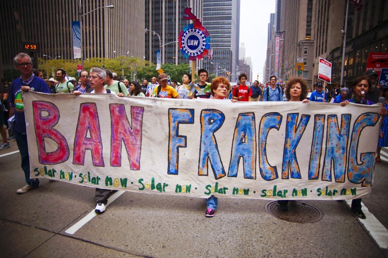 Activists march down a city street holding a Ban Fracking banner at the People's Climate March In New York City on September 24, 2014. While oil companies engage in hydraulic fracturing throughout the USA, it has proven less successful in Europe and Asia. (Flickr / Light Brigading)