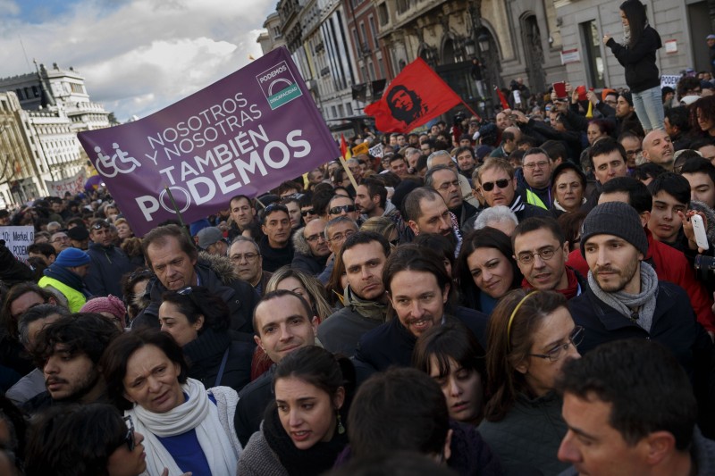 Pablo Iglesias, center right,  leader of Spanish Podemos (We Can) left-wing party, smiles as he marches to give a speech at the main square of Madrid during a Podemos (We Can) party march in Madrid, Spain, Saturday, Jan. 31, 2015. Tens of thousands of people, possibly more, are marching through Madrids streets in a powerful show of strength by Spains fledgling radical leftist party Podemos (We Can) which hopes to emulate the electoral success of Greeces Syriza party in elections later this year. Supporters from across Spain converged onto Cibeles fountain before packing the avenue leading to Puerta del Sol square. Podemos aims to shatter the countrys predominantly two-party system and the March for Change gathered crowds in the same place where sit-in protests against political and financial corruption laid the partys foundations in 2011. (AP Photo/Daniel Ochoa de Olza)