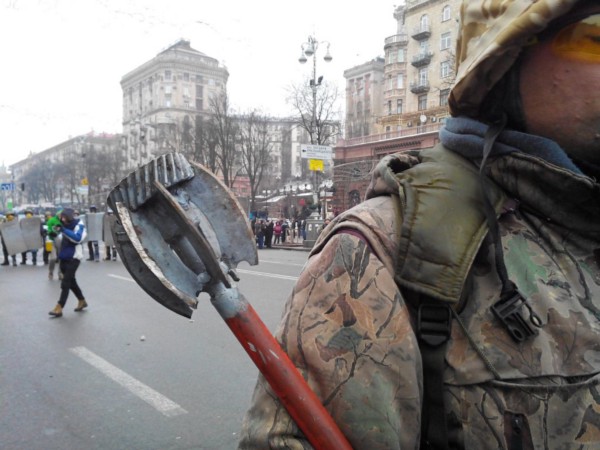 A protester in army fatigues holds a mace, while others with shields stand in the distance. Violent ‘Maidan’ protests led to a coup in Ukraine in late 2013. (Mstyslav Chernov)