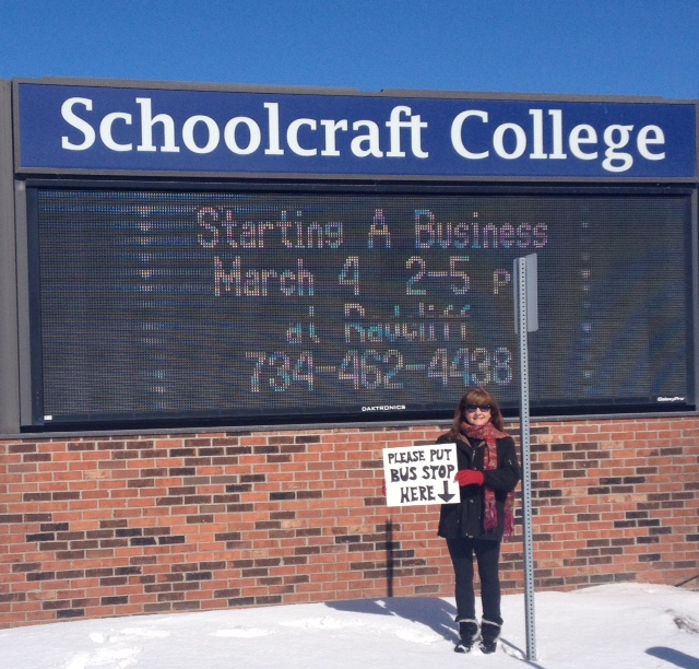 Lynda Franklin, a resident of the Detroit suburb Livonia, holds a sign reading "Please Put Bus Stop Here." Residents like Franklin are part of a growing movement pushing to rebuild Detroit transit. (Courtesy Lynda Franklin)