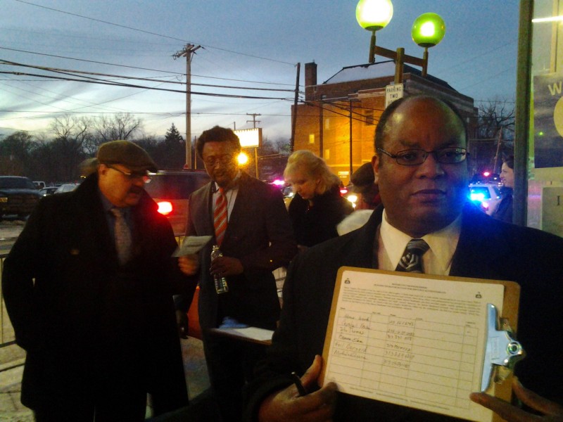 Michael Seunagal, a resident of Detroits Highland Park, holds a Motor City Freedom Riders petition demanding improved transit in the region. Seunagal, who is visually impaired, was unable to finish his schooling after Livonia opted out of Detroit transit programs. (Joel Batterman)