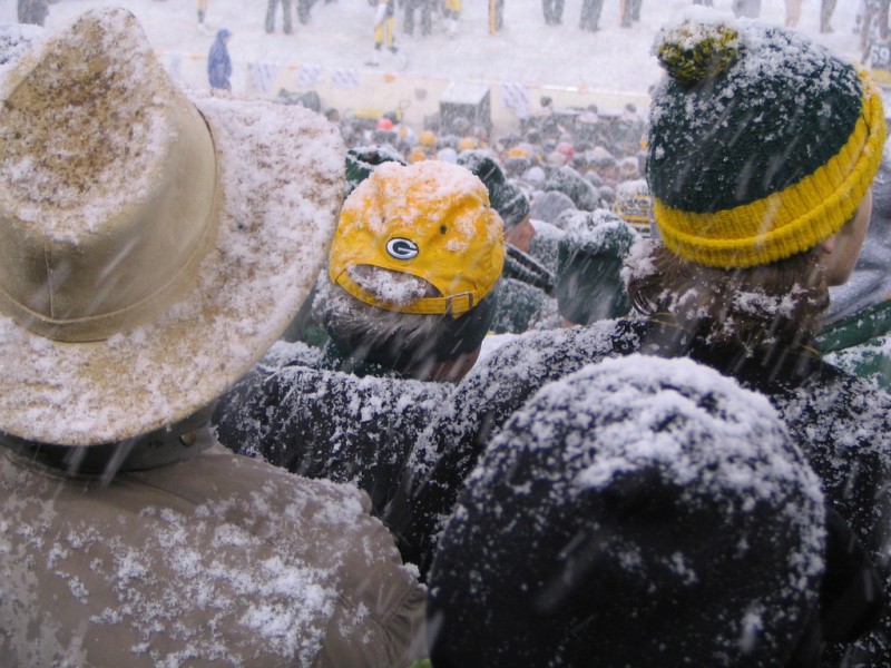 Green Bay Packers fans fill the stadium despite an active snowstorm, photographed on January 12, 2008. Collective ownership of the Packers has created a loyal community that is even willing to volunteer to shovel the field during inclement weather. Should this be a model for ownership of other sports teams, or in other industries? (Flickr / akahodag)
