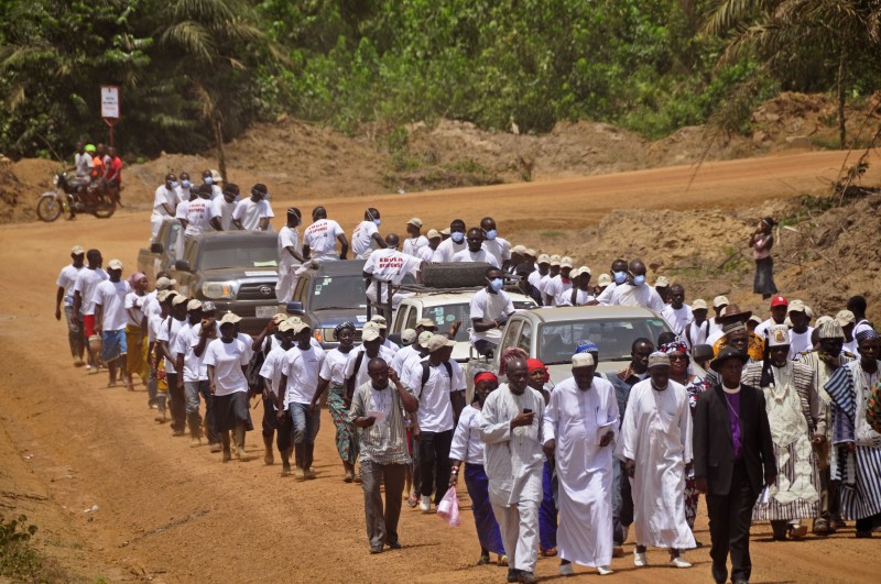 Traditional leaders walk in front of the remains of people who died due to the Ebola virus and got cremated at crematorium on the outskirts of Monrovia, Liberia, Saturday, March 7, 2015. Traditional leaders from the fifteen counties in Liberia performed prayers at a crematorium that was used to burn the remains of people that passed away due to the Ebola virus. After the ceremony at the crematorium the remains were transported to a burial site were family members and traditional leaders gave their last blessing. The West African nations of Sierra Leone, Liberia and Guinea have been hardest hit in the yearlong Ebola outbreak, which is estimated to have left more than 9,800 people dead. (AP Photo/ Abbas Dulleh)