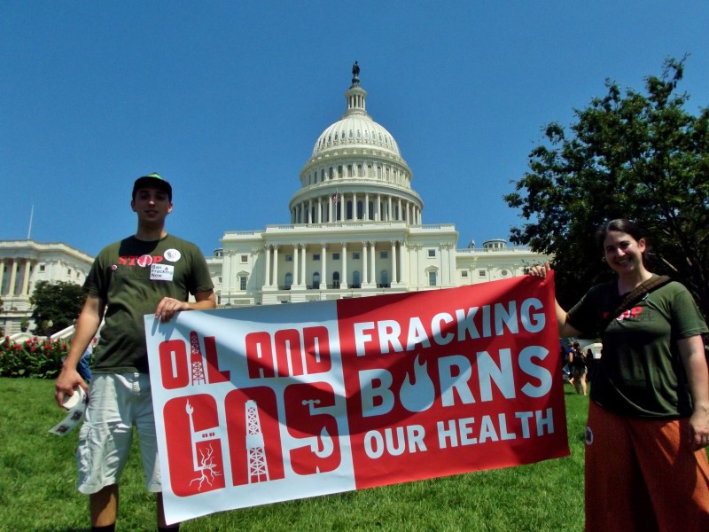At the US Capitol in Washington, DC, a pair of activists hold a banner that reads "Oil and Gas: Fracking Burns Our Health." (Flickr / Bill Baker)
