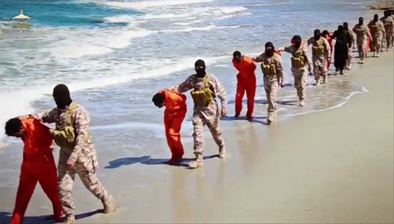 This undated image made from a video released by Islamic State militants, Sunday, April 19, 2015, shows a group of captured Ethiopian Christians taken to a beach before they were killed by Islamic State militants, in Libya. The New York Times has condemned atrocities like this one while ignoring war crimes by the US and its allies. (Militant video via AP)
