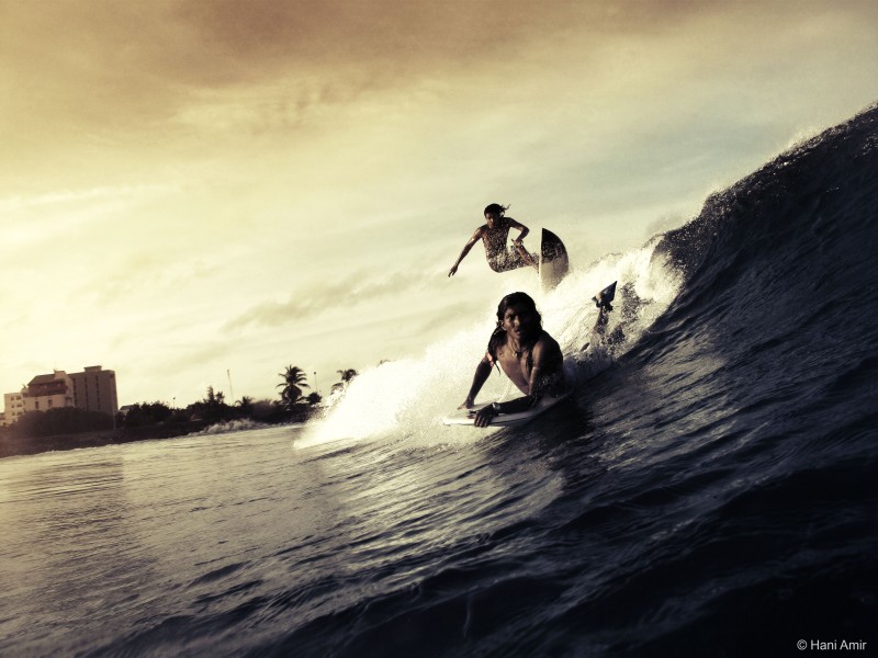 Two surfers ride a massive wave off the coast of Maldives, May 26, 2009. Will earth's people save the precious oceans before its too late? (Flickr / Hani Amir)