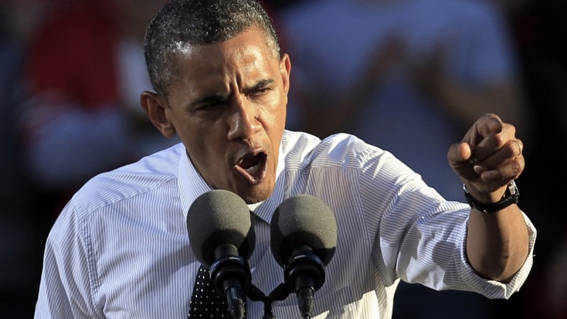 In this Oct. 9, 2012 file photo, President Barack Obama points dramatically as he speaks at a podium at Ohio State University in Columbus, Ohio. Why is the Democratic Party given a pass for the warlike behavior protested under Bush? (AP Photo/Tony Dejak, File)