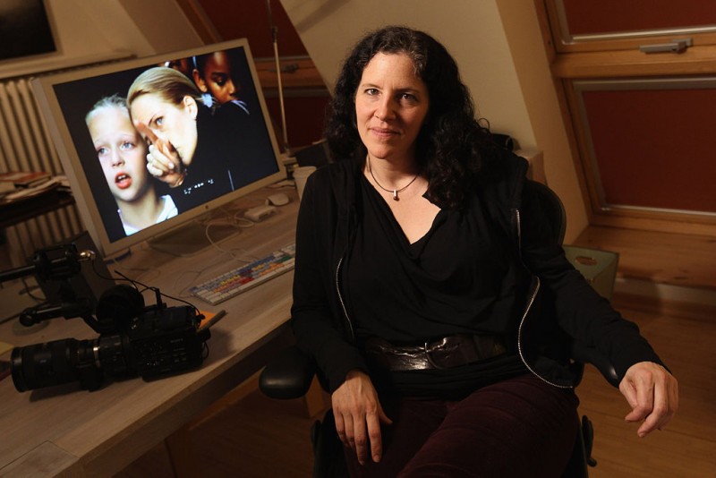 In this promotional photo from 2012, Laura Poitras sits near a desk that holds a computer showing one of her films, and a video camera. Though she stayed out of the limelight more than Edward Snowden and Glenn Greenwald, she finds herself increasingly attacked in the media after the success of "Citizenfour." (Courtesy of the John D. and Catherine T. MacArthur Foundation / Wikimedia Commons)