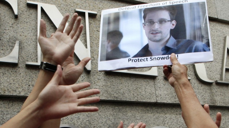 Supporters hold a picture of Edward Snowden outside the Consulate General of the United States in Hong Kong Thursday, June 13, 2013 as they urge the U.S. government to pardon Edward Snowden and to apologize for the surveillance. A new court ruling on section 215 of the USA PATRIOT Act offers new evidence supporting Snowden's revelations. (AP Photo/Kin Cheung)